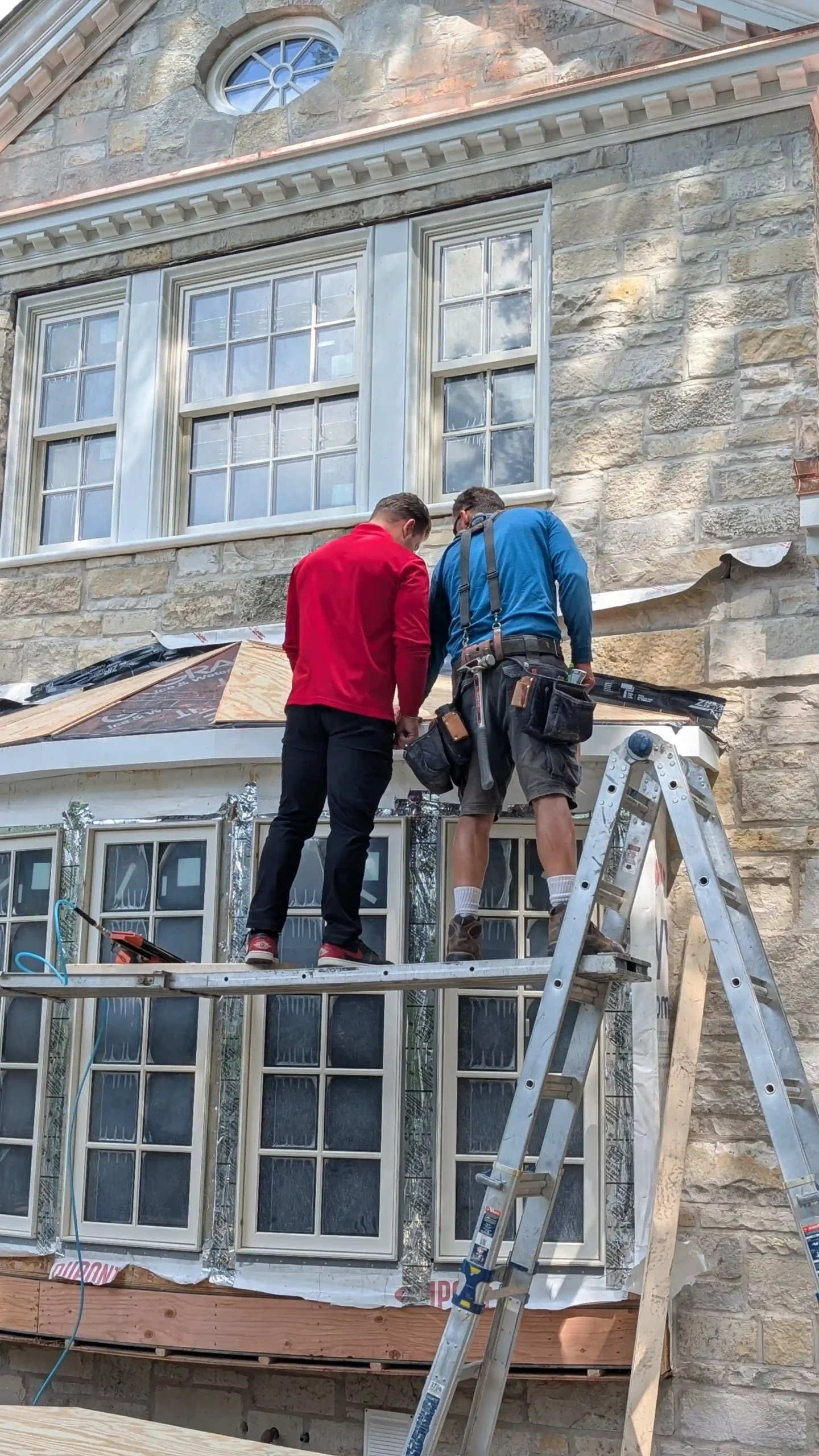 roofing contractor David Wilk talking to roofer about the project