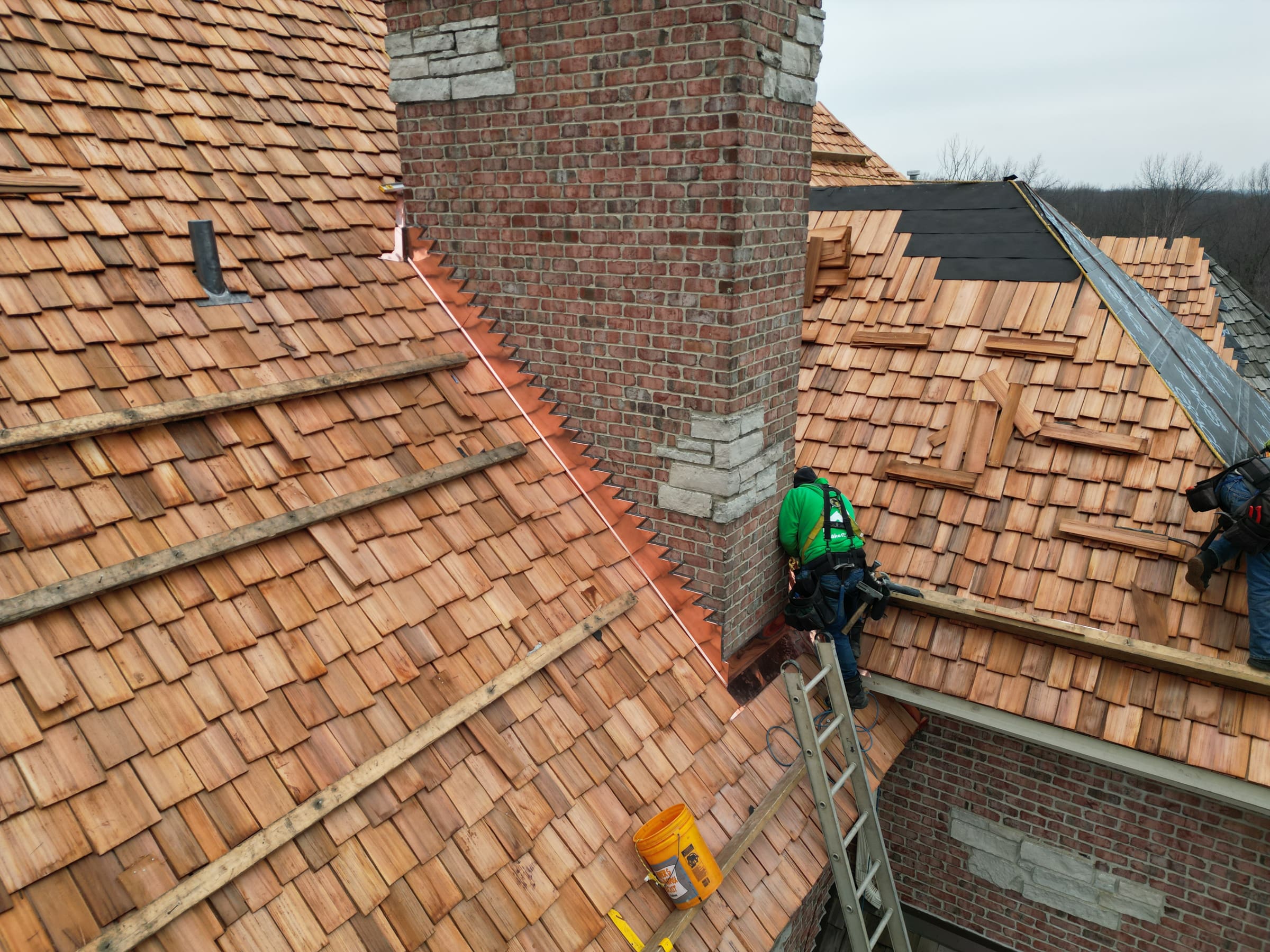 Close-up of cedar shake roof installation by Wolf Development