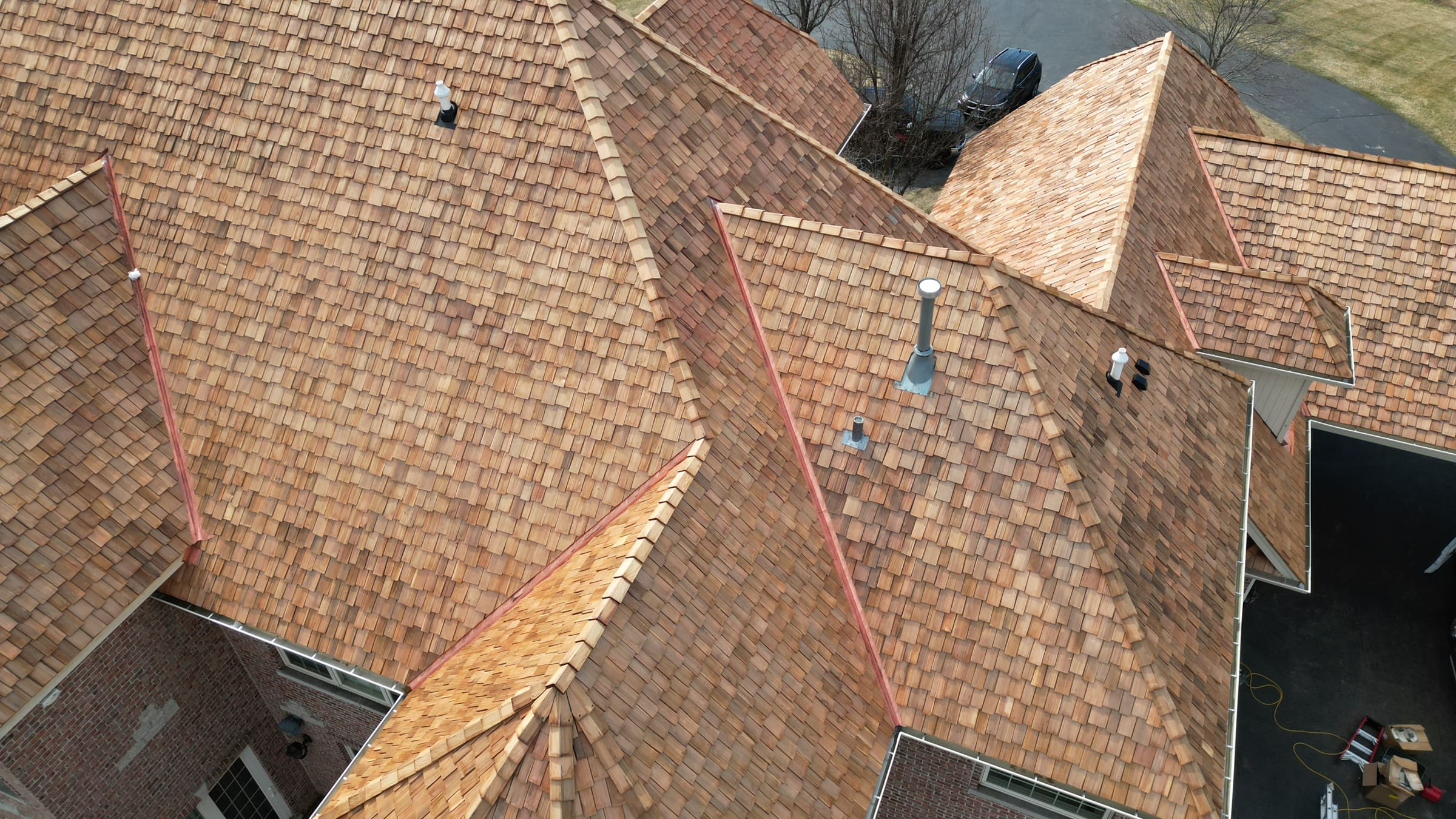 Close-up of cedar shake roof installation by Wolf Development