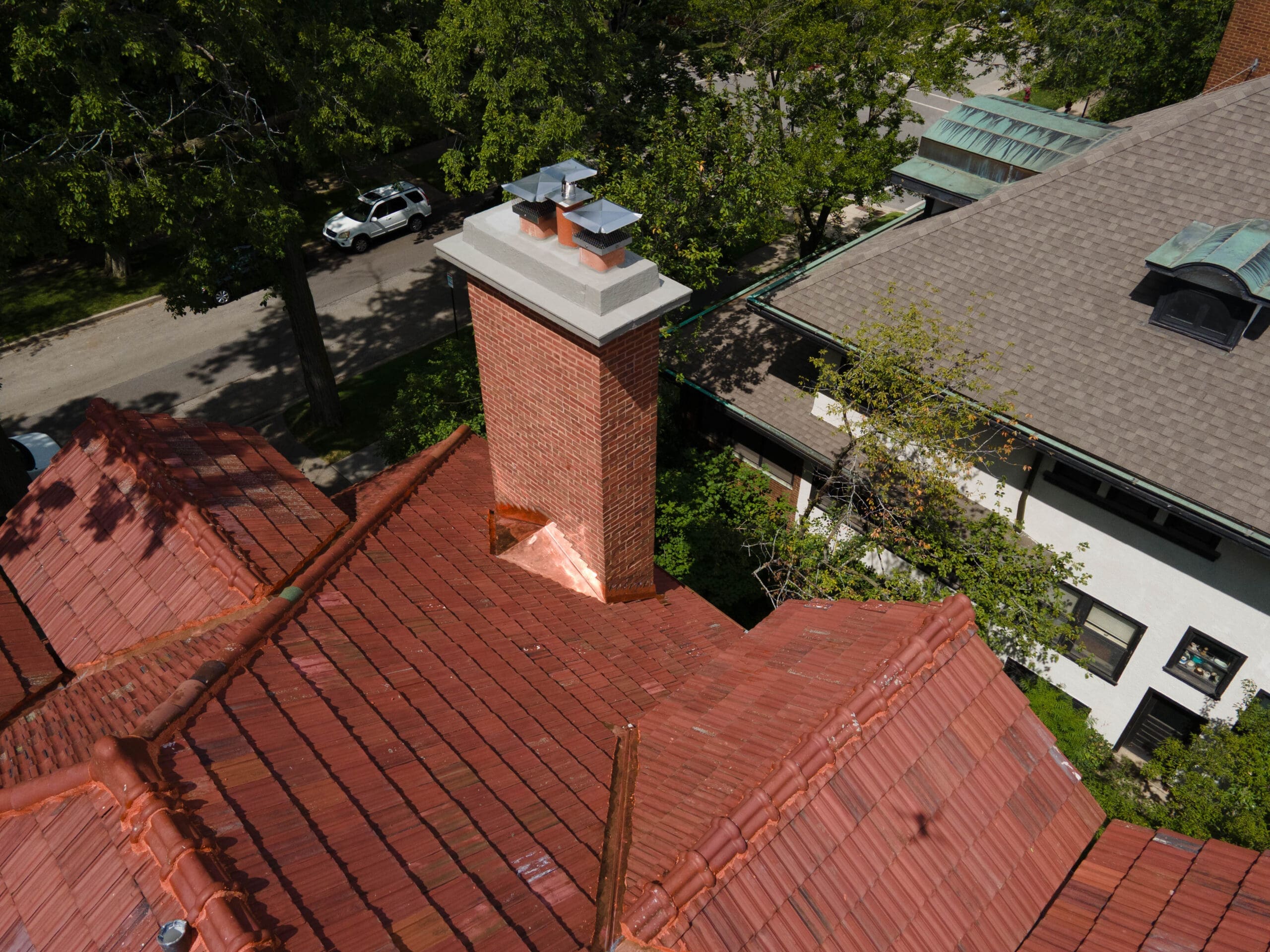 New copper chimney flashing installed during Evanston tile roof restoration