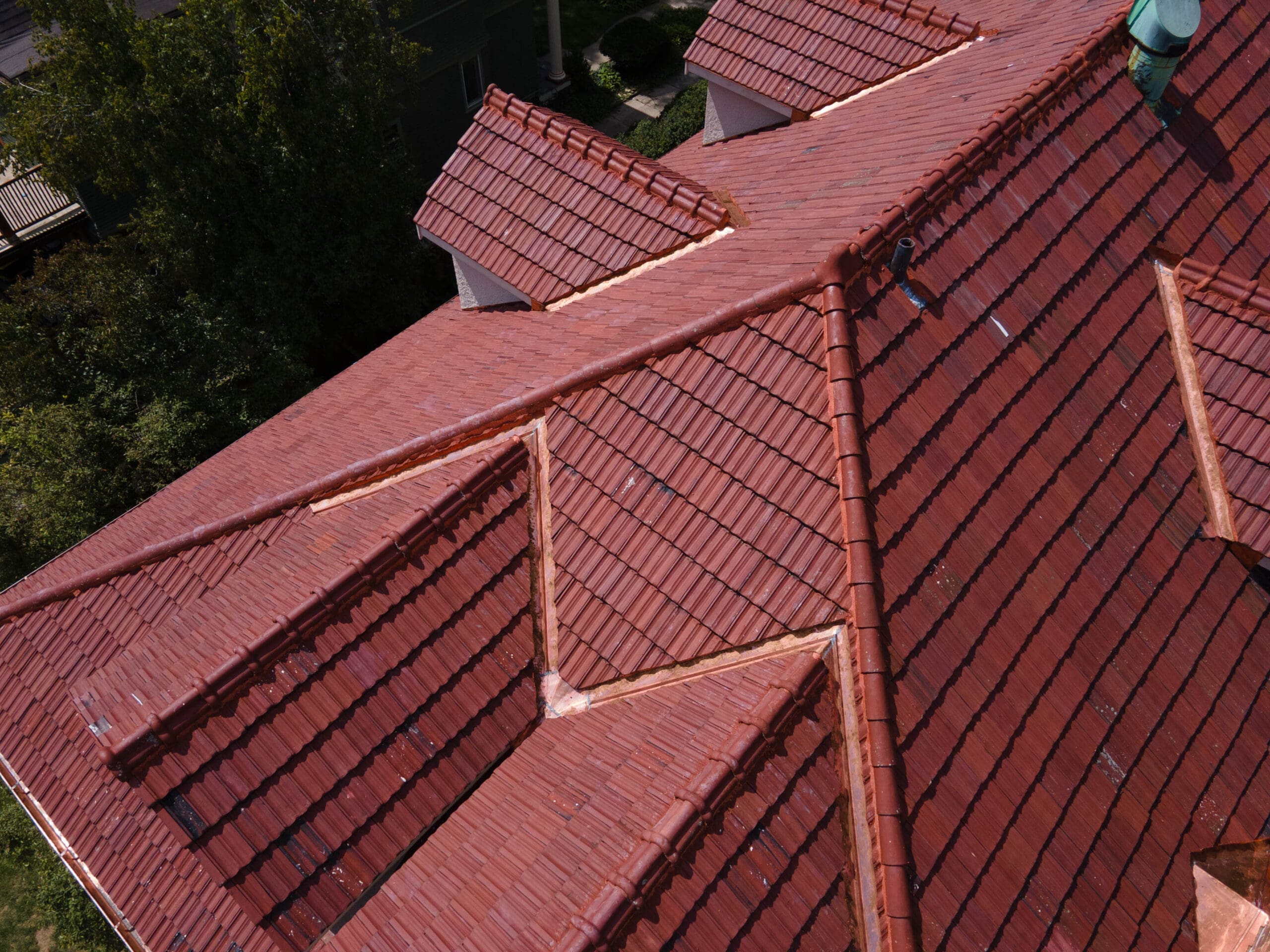 Close-up of restored clay roof tiles matched to original Evanston 1960s roof