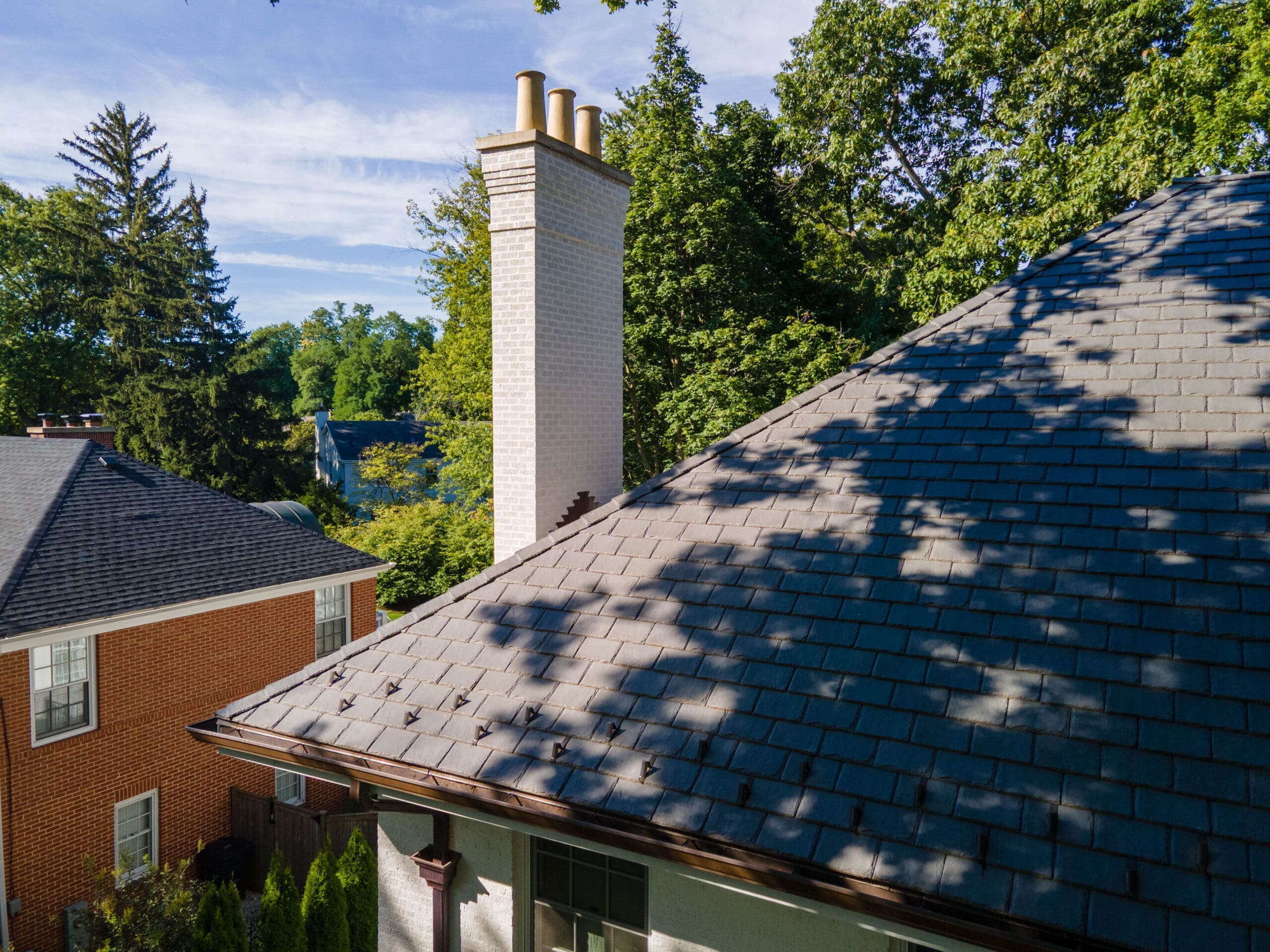 Snow guards installed along roofline for winter protection on Winnetka slate roof