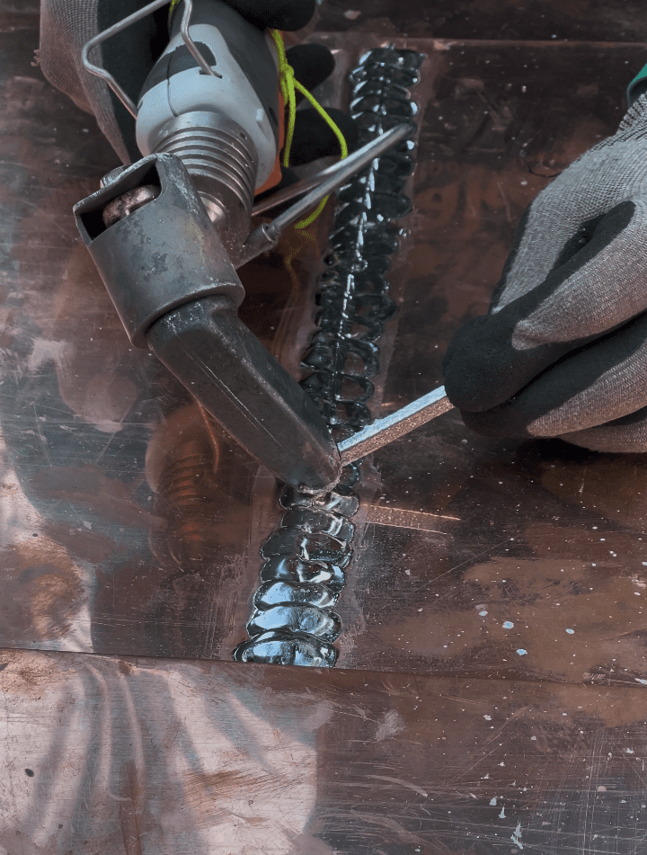 roofer welding copper roof- detail view