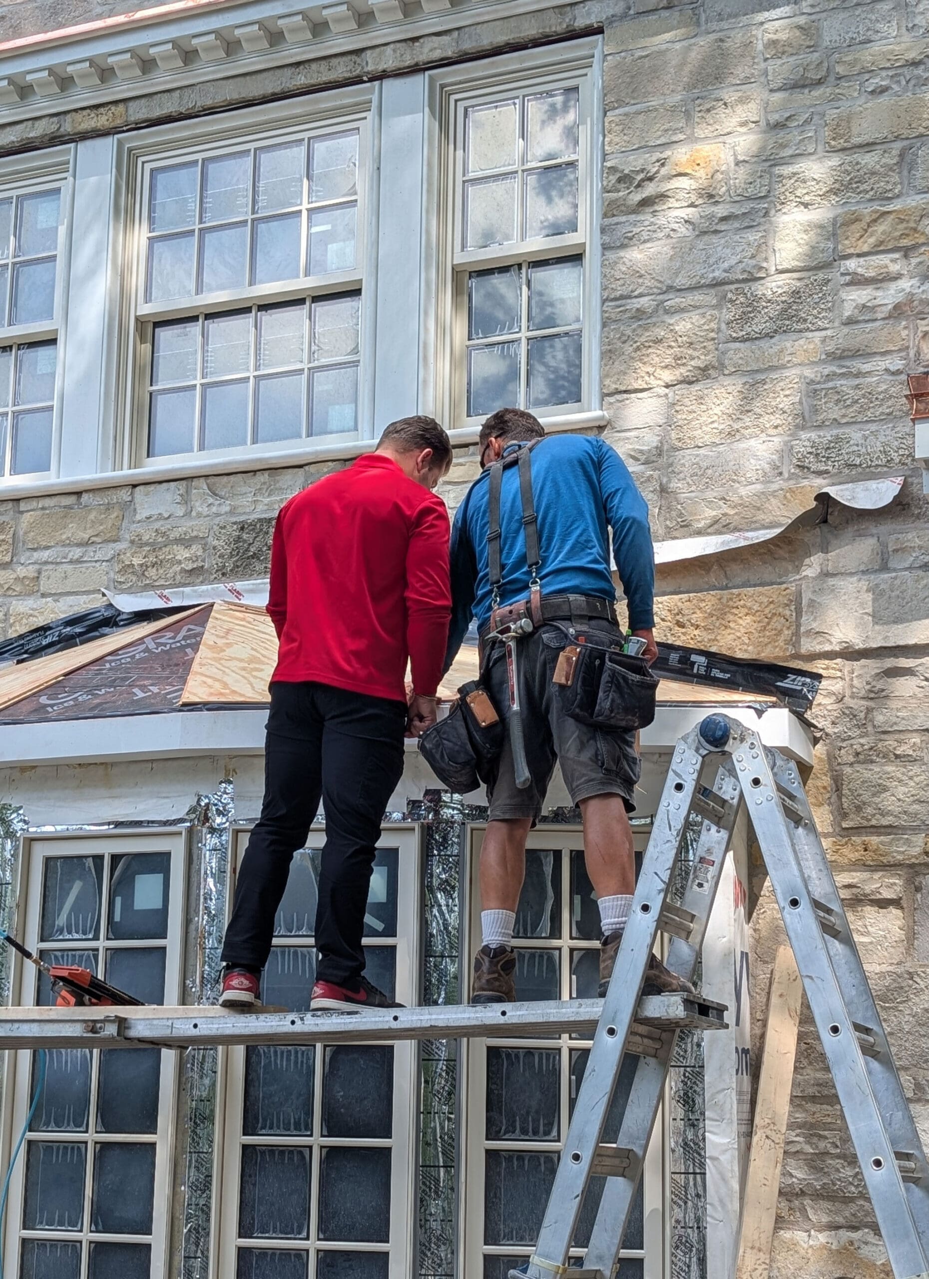 David Wilk consulting with his roofer regarding roofing materials